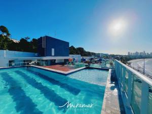 a swimming pool on the roof of a building at Blue Sunset Frente Mar Cabo Branco-Miramar Hospedagens in Penha