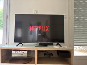 a flat screen tv sitting on top of a table at Maison de ville avec jardin clos 4 Pers in Saint-Pol-de-Léon