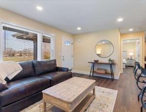 a living room with a leather couch and a table at Diana's Place - 6 BDR Ranch Long or Short Stays in Murfreesboro