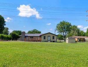 a house on a grassy field with a house at Diana's Place - 6 BDR Ranch Long or Short Stays in Murfreesboro