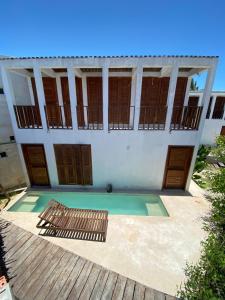 a building with a pool in front of it at For Large group, UP TO 10 people Entire Space Rental 3 lodges with private pools in Holbox Island