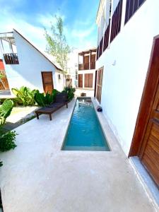 a swimming pool in the courtyard of a building at For Large group, UP TO 10 people Entire Space Rental 3 lodges with private pools in Holbox Island
