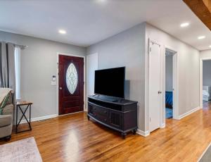 a living room with a flat screen tv on a entertainment center at Cozy Franklin Hideaway - For 5 in Franklin