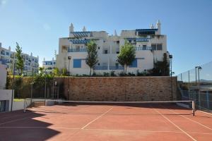 a tennis court in front of a building at Luxury Apartment, Kabila Vista, MDiq, Morocco in M'diq