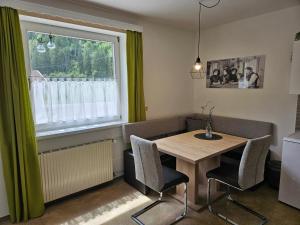 a dining room with a table and chairs and a window at Apartment Iseltal in Matrei in Osttirol
