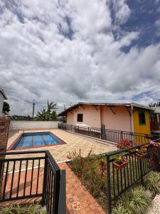 a house with a swimming pool next to a building at Finca La Carolina in Jericó