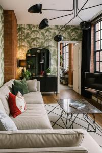 a living room with a couch and a table at City Penthouse with 3 floors , Super King Bed , with secret garden in Birmingham