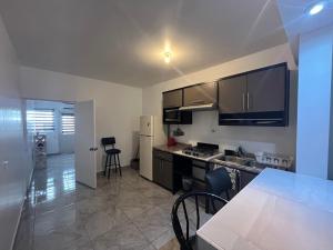 a kitchen with stainless steel appliances and a table and chairs at Departamentos MAC in Manuel F. Martínez