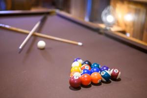 a group of billiard balls on a pool table at After the Sunset 1-Level 5BR Pool - Arcade in Broken Bow
