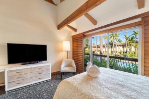 a bedroom with a bed with a flat screen tv at Humphreys Half Moon Inn in San Diego