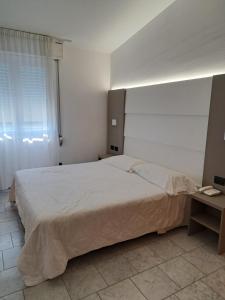 Postel nebo postele na pokoji v ubytování Hotel Consuelo