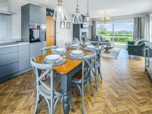 a kitchen and dining room with a wooden table and chairs at Bellshill Bothy in Newlands