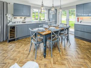 a kitchen with a dining room table and chairs at Bellshill Bothy in Newlands