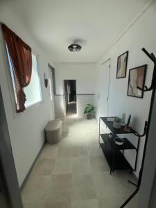 a hallway with a room with a toilet and a table at Charmante maison de campagne in Azy-le-Vif