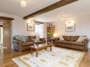 a living room with two couches and a coffee table at The Farmhouse At Westwater in Axminster
