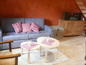 a living room with two tables and a couch at Le Bacchus in Barr