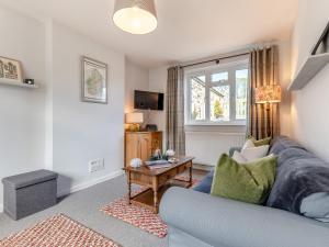 a living room with a couch and a table at 3 Bed in Bamburgh 90351 in Belford