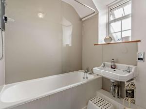 a white bathroom with a sink and a tub and a sink at 2 Bed in Wooler 50973 in Crookham +20 photos