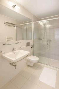 a bathroom with a toilet and a sink and a shower at Guest House Neho in Cres