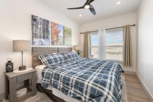 a bedroom with a bed and a ceiling fan at Modern Granby Wonder by Leavetown Vacations in Granby +47 photos