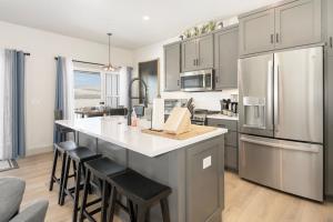 a kitchen with stainless steel appliances and a large island at Modern Granby Wonder by Leavetown Vacations in Granby