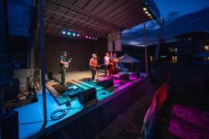 a group of people on a stage at night at Modern Granby Wonder by Leavetown Vacations in Granby