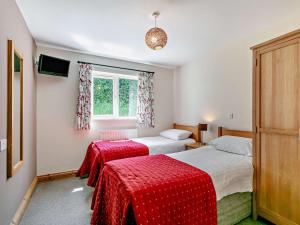 a bedroom with two beds and a window at 3 Bed in Crediton WAIE3 in Zeal Monachorum +29 photos