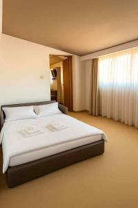 a bedroom with a large white bed with a window at Guest House Neho in Cres +49 photos