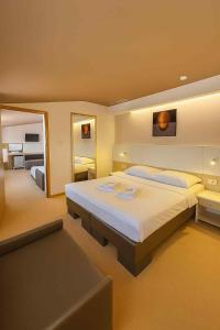 a large bedroom with a large bed and a couch at Guest House Neho in Cres