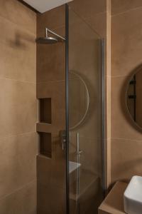 a shower with a glass door in a bathroom at Lumora Suites in Kavos