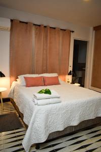 a bedroom with a white bed with towels on it at 10 Céntrico y Confortable apto Casa Doña Yola in Cartagena de Indias