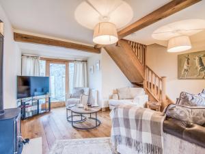 a living room with a couch and a tv at 3 Bed in Hartington 77739 in Hartington