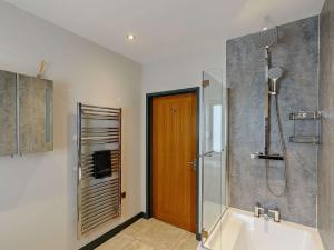 a bathroom with a shower and a bath tub at 4 bed in Bodle Street Green 91157 in Warbleton +28 photos