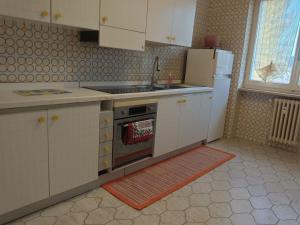 a kitchen with a stove and a refrigerator at Alle porte del Monterosa in Serravalle Sesia