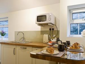a kitchen with two plates of food on a counter at New Cottage in Egton