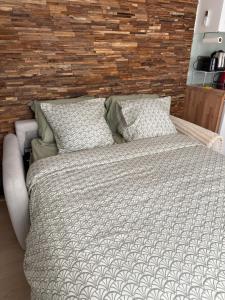 a bedroom with a large bed and two pillows at Superbe cocon chic, clim et terrasse privée, déco soignée in Nevers