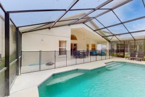 an indoor swimming pool with a glass ceiling at Cumbrian Lakes Villa in Kissimmee