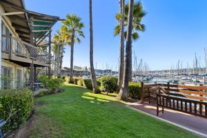 a yard with palm trees and a marina at Humphreys Half Moon Inn in San Diego