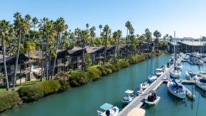 a group of boats docked in a river with houses at Humphreys Half Moon Inn in San Diego