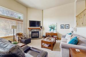 a living room with a couch and a fireplace at Bobsled Haven in Park City