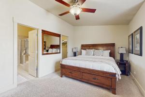 a bedroom with a bed and a ceiling fan at Bobsled Haven in Park City +24 photos