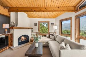 a living room with a couch and a fireplace at Shadow Mountain 10 in Aspen +37 photos