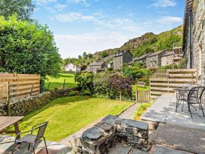 a patio with a stone fire pit in a yard at 3 Bed in Chapel Stile SZ161 in Chapel Stile