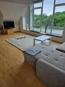 a living room with a couch and a table at Waldeslust Pension in Oelde
