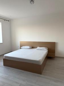 a bedroom with a large bed with white sheets at Millo Apartament in Bucharest