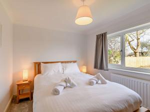 a bedroom with a large white bed with two pillows at 4 Bed in Embleton 89964 in Christon Bank