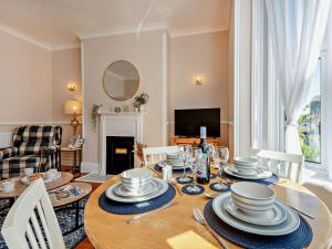 a dining room with a table with dishes on it at 2 Bed in Swanage 90116 in Swanage