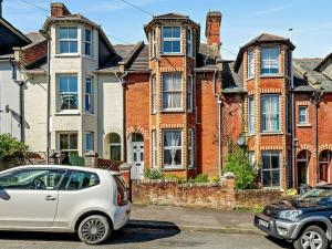 a white car parked in front of a house at 2 Bed in Swanage 90116 in Swanage