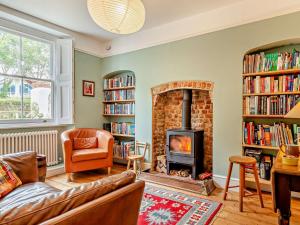 a living room with a couch and a fireplace at 3 Bed in Charmouth 93420 in Charmouth