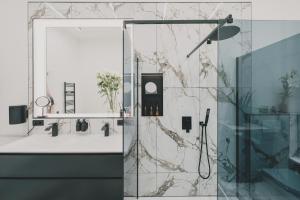 a bathroom with a shower with a glass door at Altbauloft im Herzen Berlins in Berlin +71 photos